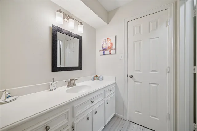 a bathroom with a double vanity sink and a mirror