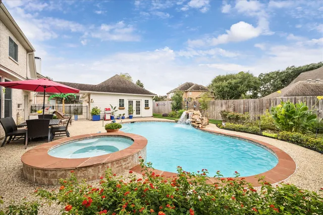 a view of a house with swimming pool and sitting area