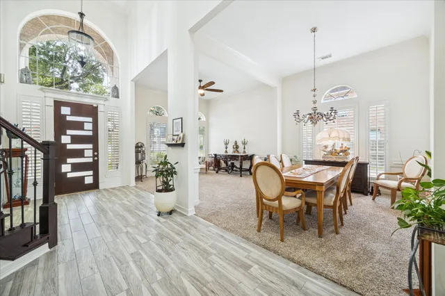 a view of a dining room with furniture and chandelier