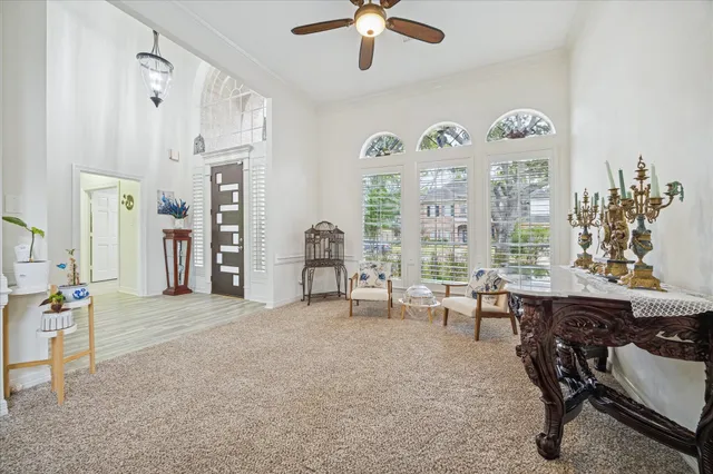a view of a livingroom with workspace and a window