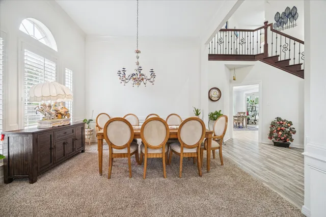 a dining room with furniture a chandelier and window
