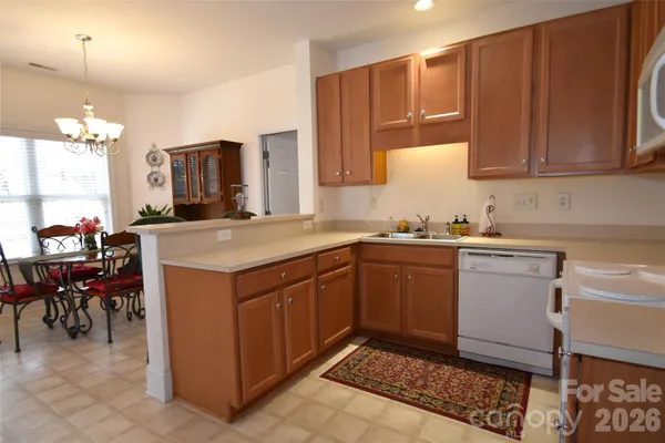 a kitchen with a sink cabinets and window