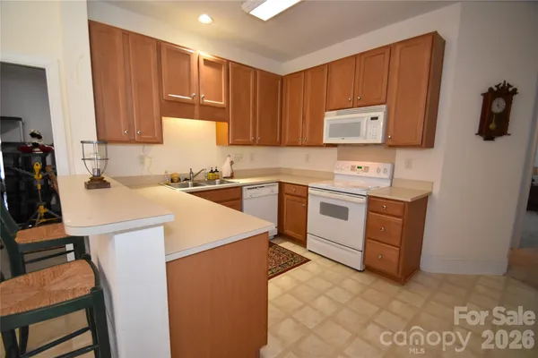 a utility room with sink dryer and washer