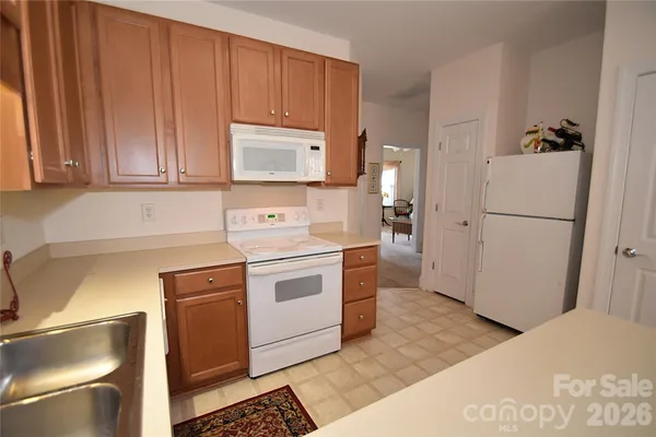 a kitchen with a refrigerator sink and cabinets