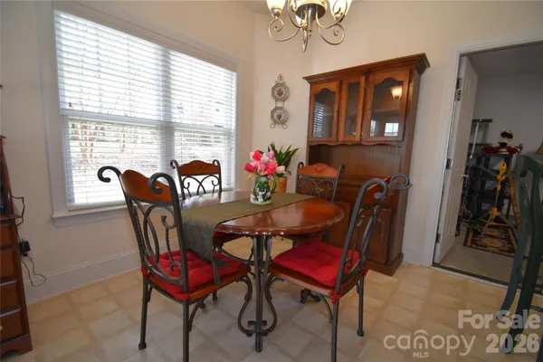 a view of a dining room with furniture and chandelier