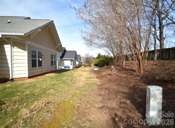 a backyard of a house with large trees