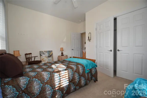 a bedroom with a bed and flowerpot