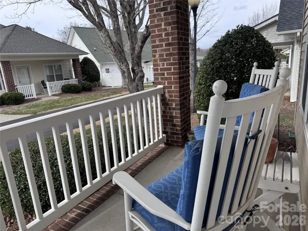 a view of a porch with wooden floor and fence