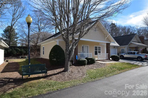 a front view of a house with garden and porch