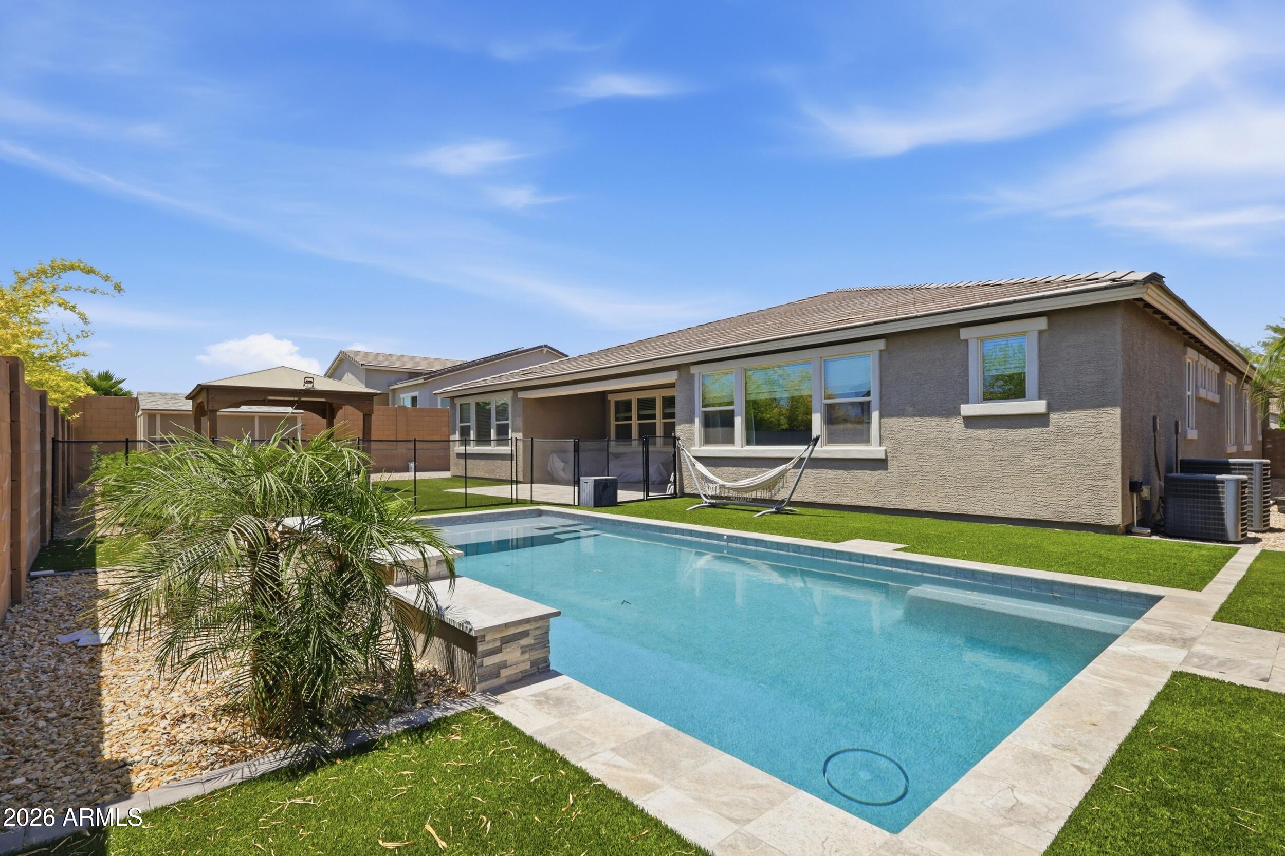 12517 West Lawrence Road Glendale, AZ 85307 - Photo 51 of 52 a view of a house with swimming pool and a yard