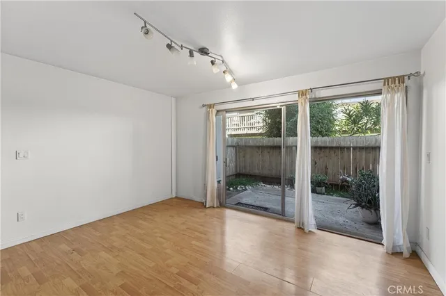 a view of a room with wooden floor garden view and a window