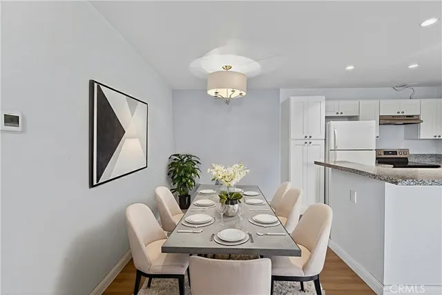 a view of kitchen with kitchen island white cabinets and refrigerator