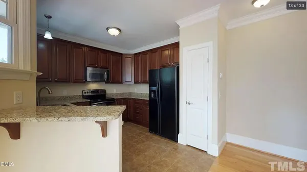a kitchen with a refrigerator a stove top oven a sink and dishwasher