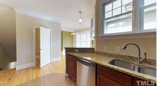 a kitchen with granite countertop a sink and cabinets