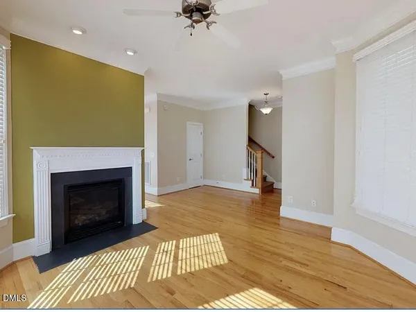a living room with a fireplace furniture and a ceiling fan