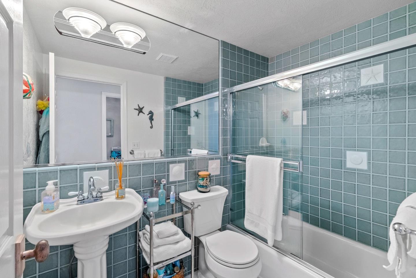 4940 Capitola Road Capitola, CA 95010 - Photo 11 of 25 a bathroom with a sink mirror toilet and shower