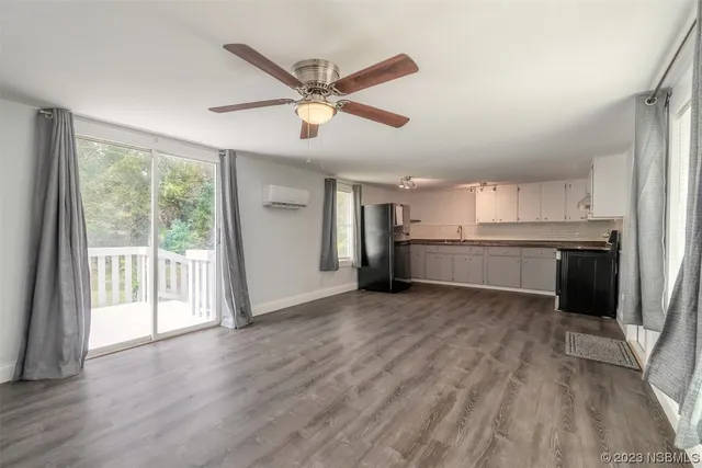 a view of a kitchen with a sink dishwasher cabinets and wooden floor