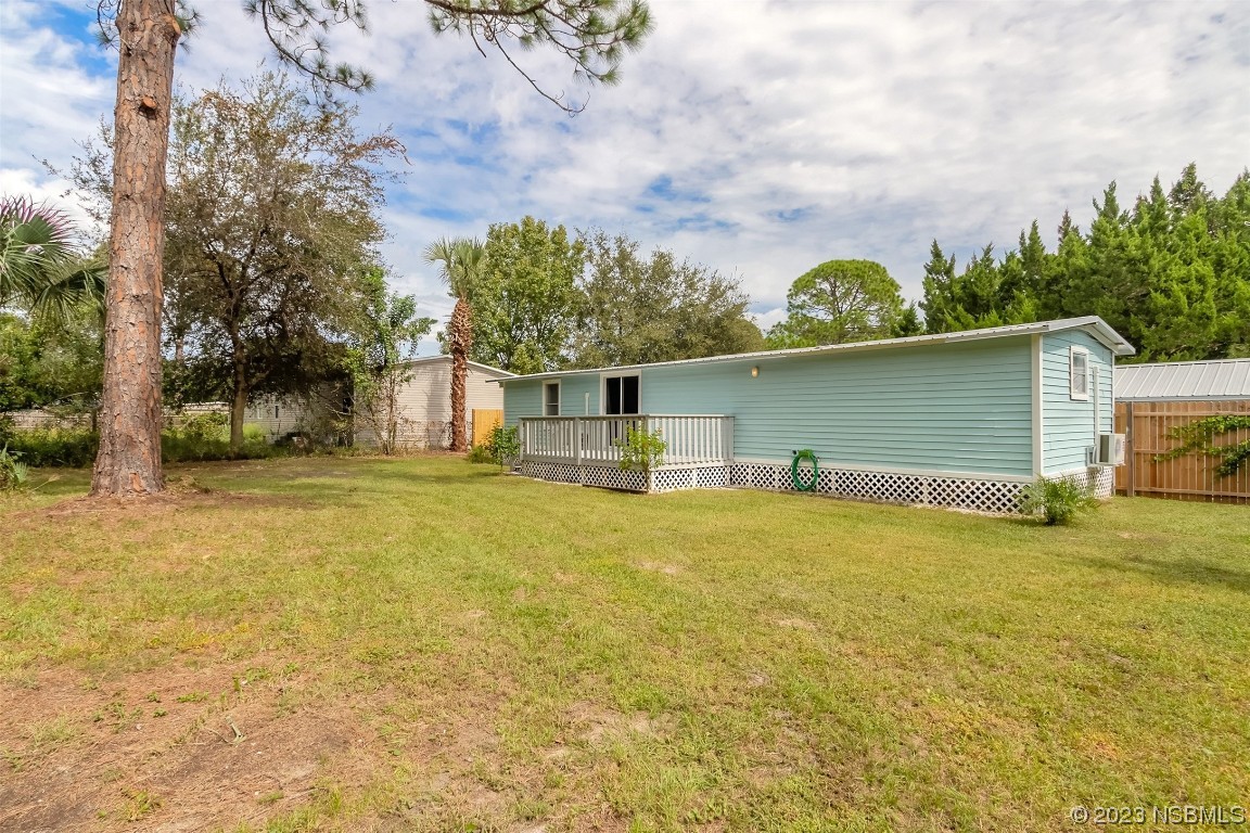 153 West Loop Oak Hill, FL 32759 - Photo 21 of 32 a front view of a house with a yard
