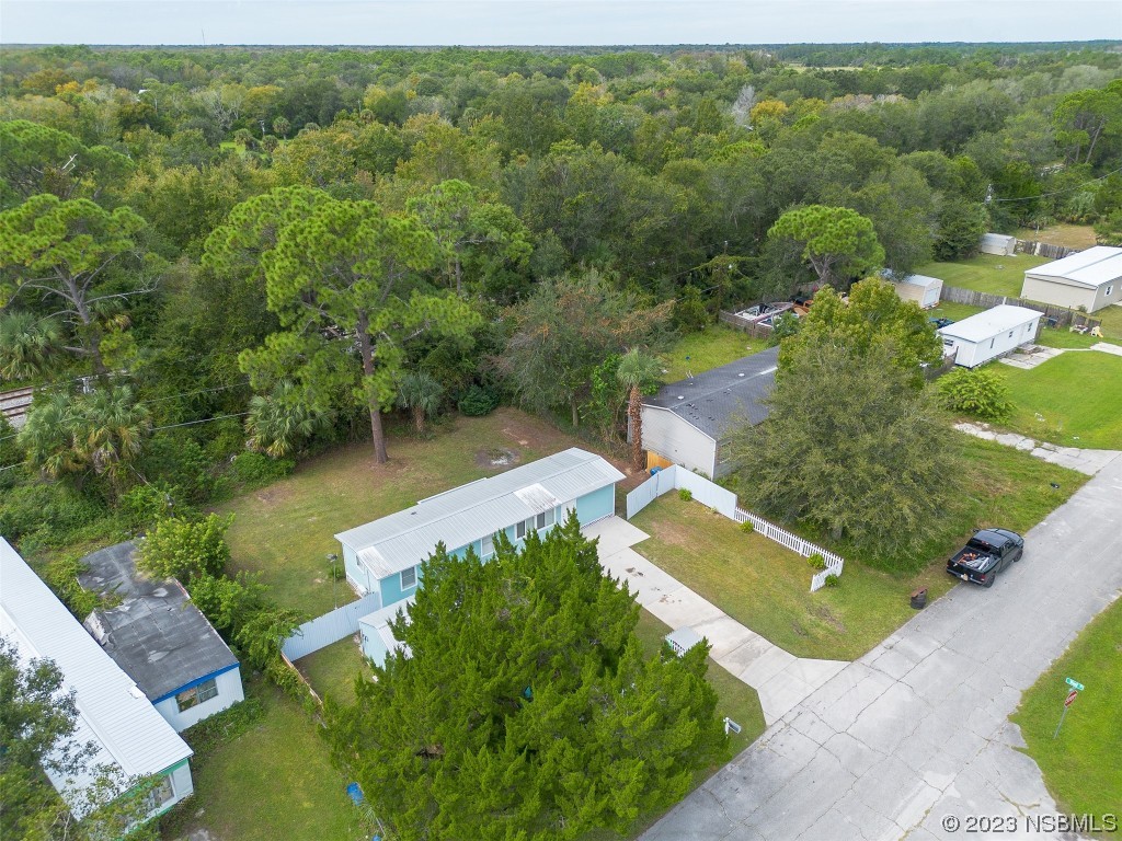 153 West Loop Oak Hill, FL 32759 - Photo 25 of 32 an aerial view of a house with a yard