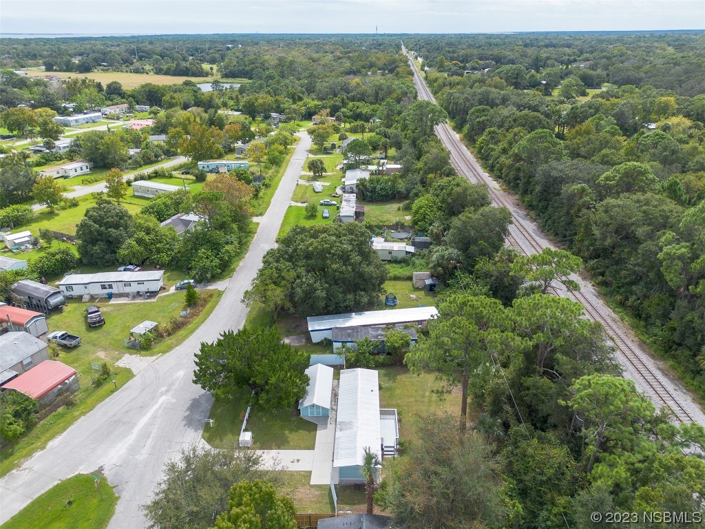 153 West Loop Oak Hill, FL 32759 - Photo 30 of 32 an aerial view of residential houses with outdoor space and trees