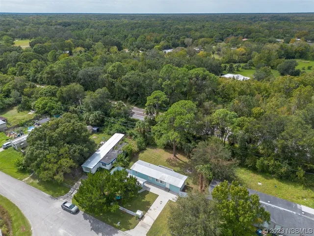 an aerial view of a house with yard
