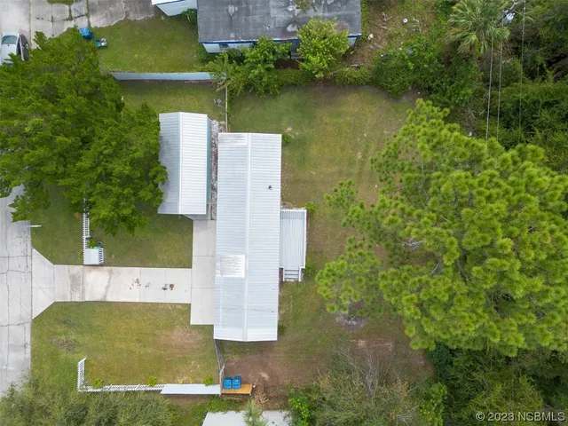 an aerial view of a house with a yard basket ball court and outdoor seating