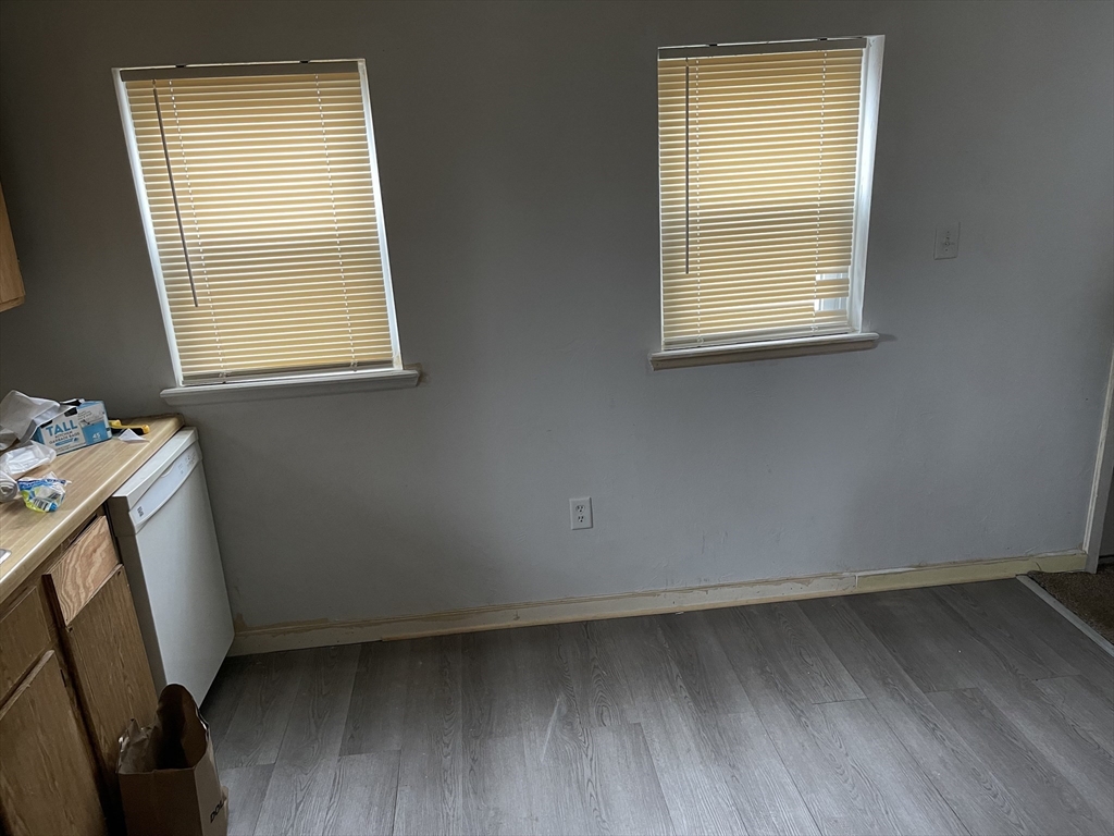 22 Commonwealth Avenue, Unit 1 North Attleboro, MA 02760 - Photo 2 of 6 a utility room with window and dryer