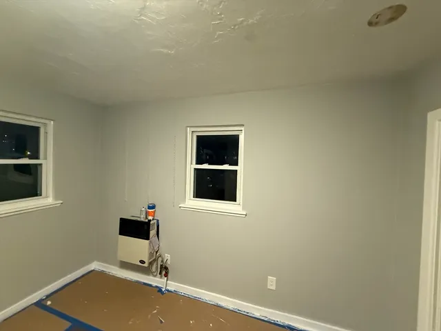 a view of table room with window and wooden floor
