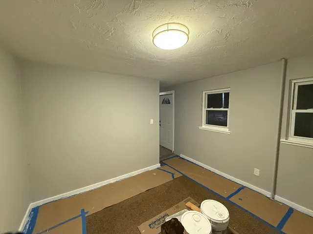 a view of a room with wooden floor and bathroom