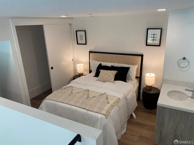 a bedroom with a bed and a lamp