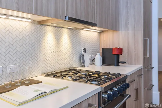 a kitchen with a stove and a white cabinet
