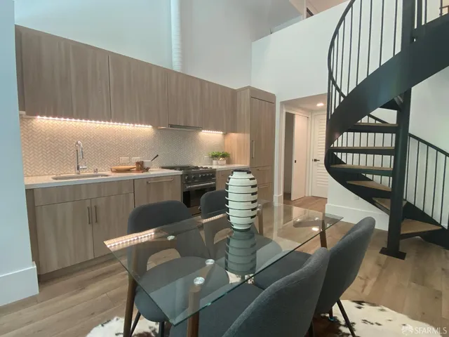 a dining room with furniture and wooden floor