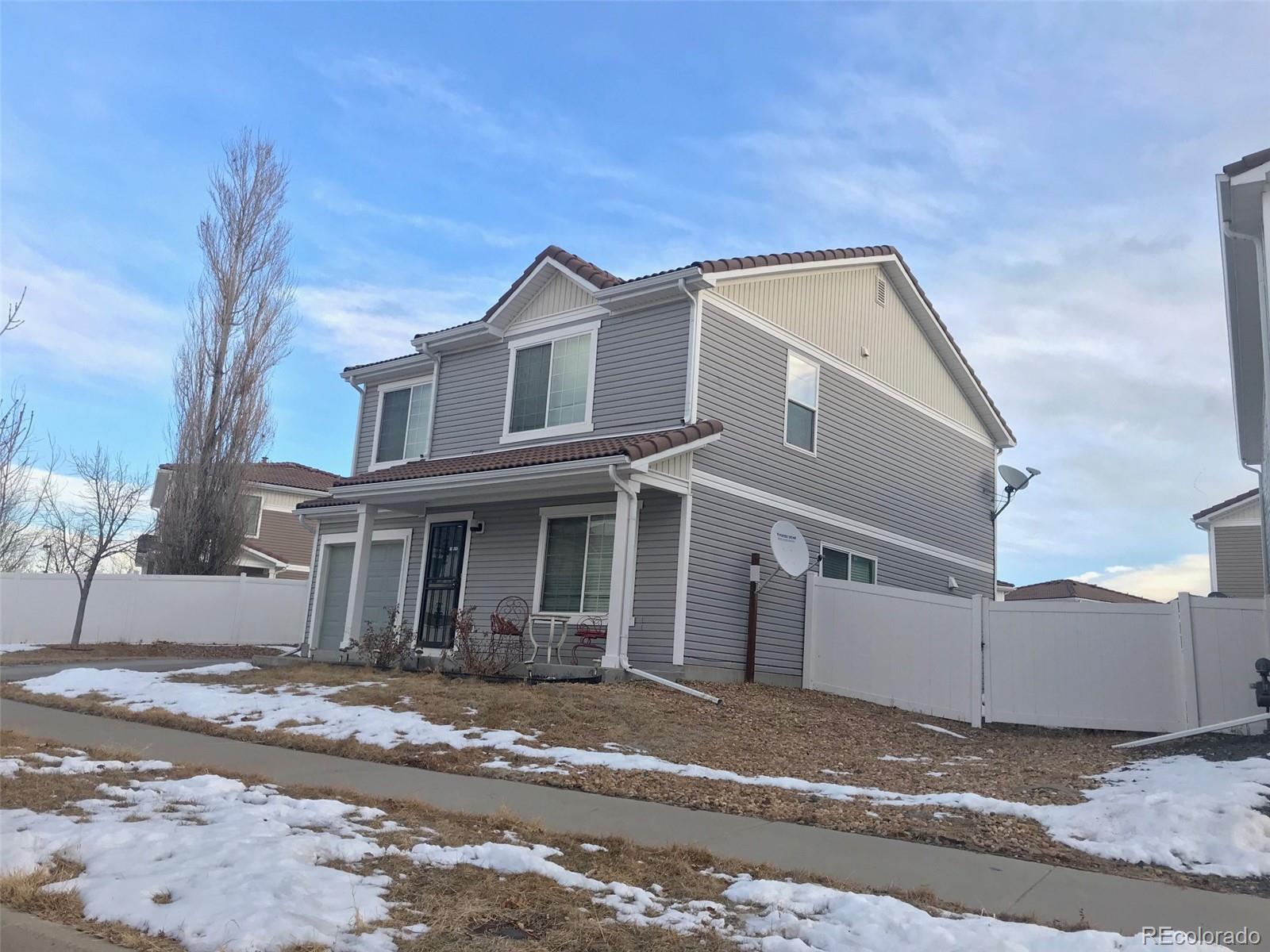 5556 Flanders Way Denver, CO 80249 - Photo 1 of 23 a view of a white house with a street