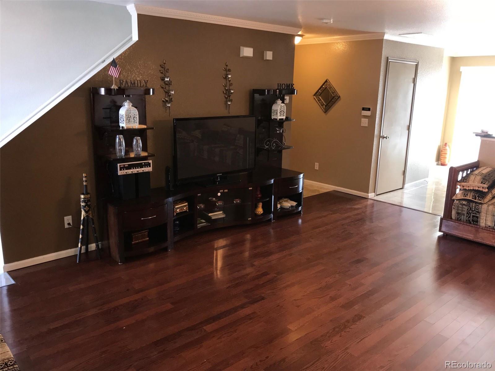 5556 Flanders Way Denver, CO 80249 - Photo 4 of 23 a view of a livingroom with furniture and wooden floor