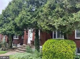 front view of a house with a tree
