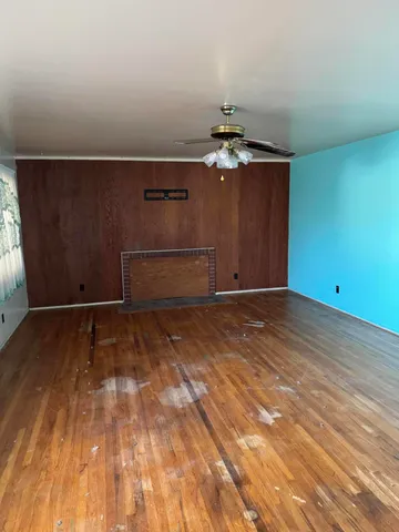 a view of a room with wooden floor