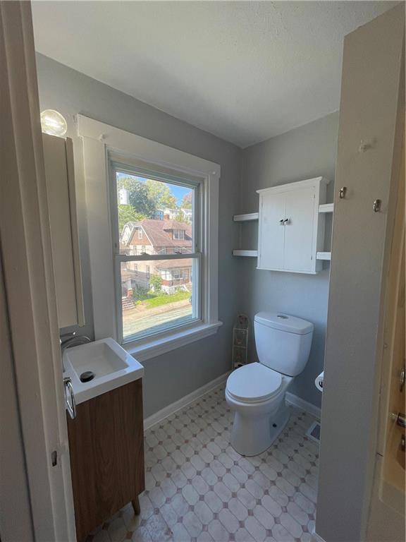 519 North Monroe Street Butler, PA 16001 - Photo 16 of 32 a bathroom with a toilet a sink and a window