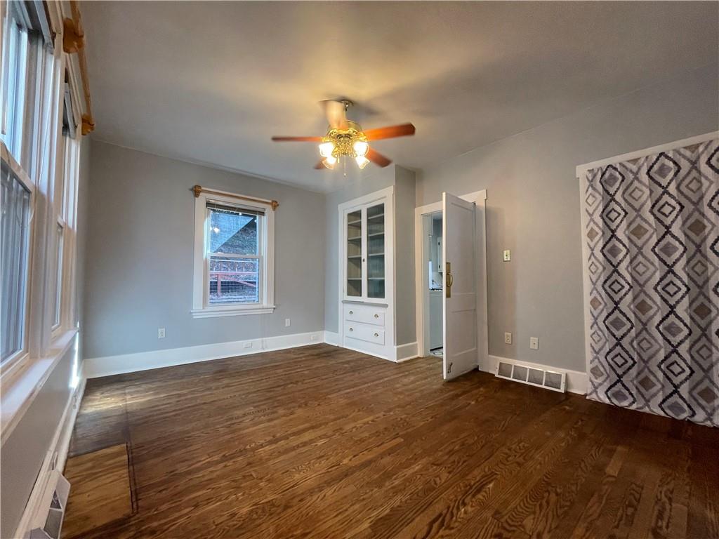 519 North Monroe Street Butler, PA 16001 - Photo 8 of 32 an empty room with wooden floor chandelier fan and windows