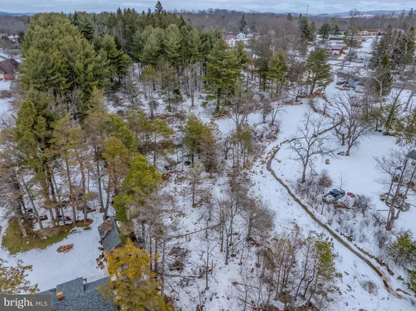 a aerial view of a house with a yard and garden