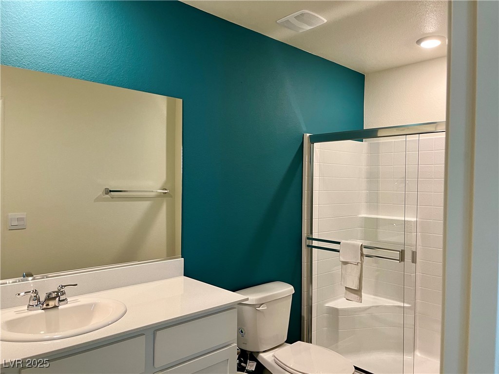 4862 Orchid Rdg Avenue Las Vegas, NV 89141 - Photo 23 of 48 Primary bath w/quartz counters, white shaker cabinets & walk in shower.