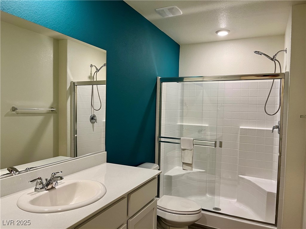 4862 Orchid Rdg Avenue Las Vegas, NV 89141 - Photo 24 of 48 Primary bath w/quartz counters, white shaker cabinets & walk in shower.