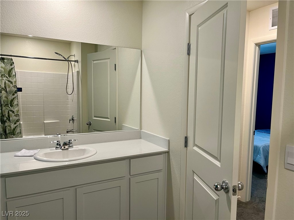 4862 Orchid Rdg Avenue Las Vegas, NV 89141 - Photo 34 of 48 Secondary bath w/quartz counters, white shaker cabinets and tub/shower combo.