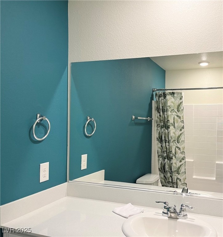 4862 Orchid Rdg Avenue Las Vegas, NV 89141 - Photo 35 of 48 Secondary bath w/quartz counters, white shaker cabinets and tub/shower combo.