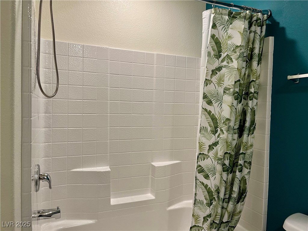 4862 Orchid Rdg Avenue Las Vegas, NV 89141 - Photo 37 of 48 Secondary bath w/quartz counters, white shaker cabinets and tub/shower combo.