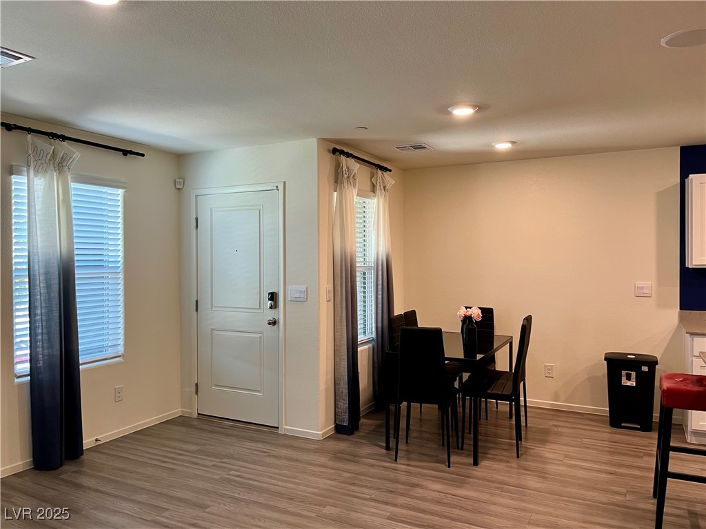 4862 Orchid Rdg Avenue Las Vegas, NV 89141 - Photo 5 of 48 Living room with luxury vinyl plank floors, ceiling light, blinds & curtains.