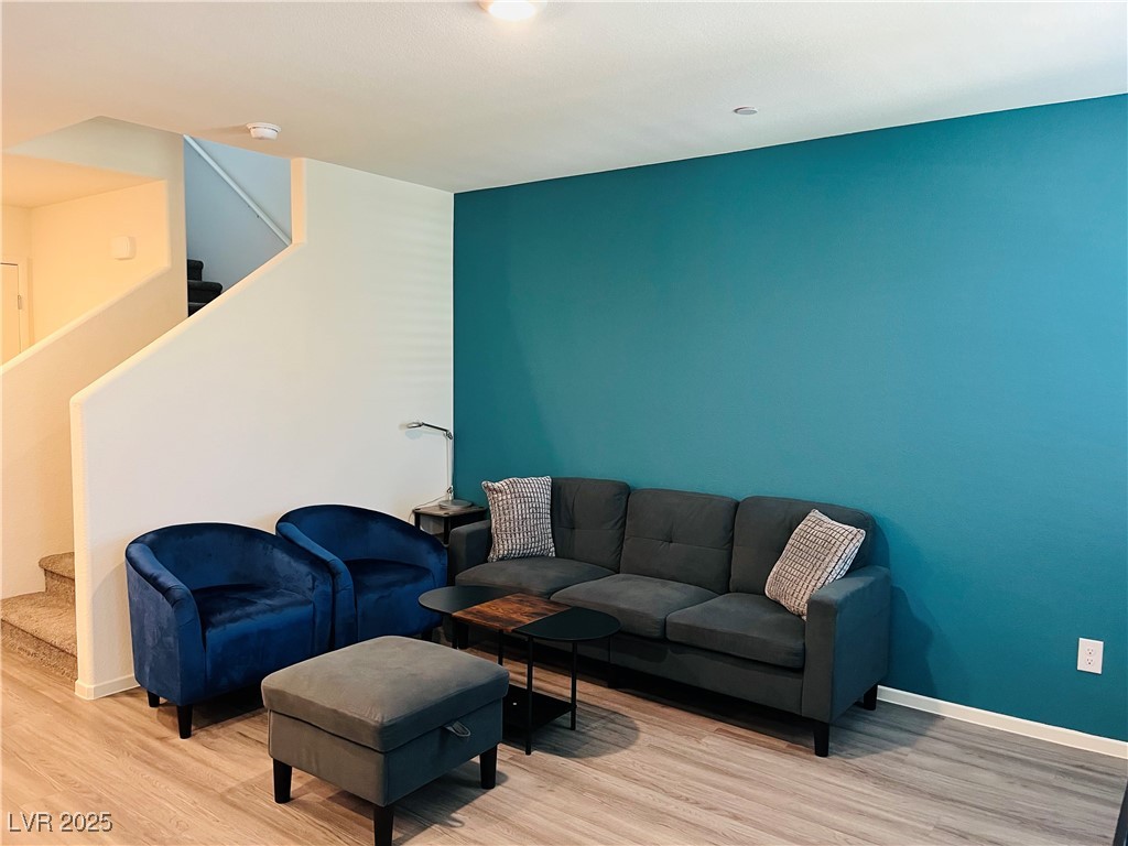 4862 Orchid Rdg Avenue Las Vegas, NV 89141 - Photo 8 of 48 Living room with luxury vinyl plank floors, ceiling light, blinds & curtains.