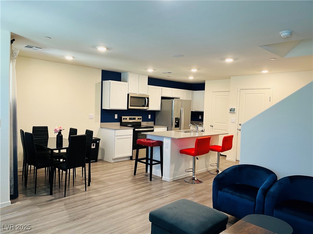4862 Orchid Rdg Avenue Las Vegas, NV 89141 - Photo 9 of 48 Dining area with luxury vinyl plank floors, ceiling light.