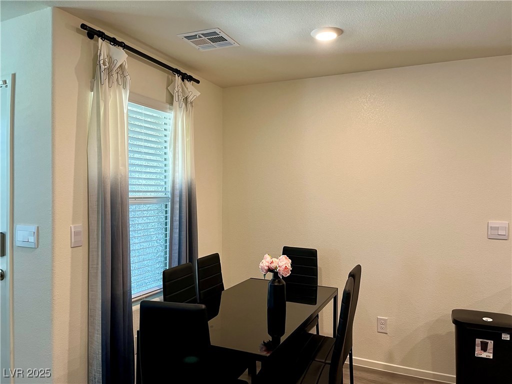 4862 Orchid Rdg Avenue Las Vegas, NV 89141 - Photo 10 of 48 Dining area with luxury vinyl plank floors, ceiling light.