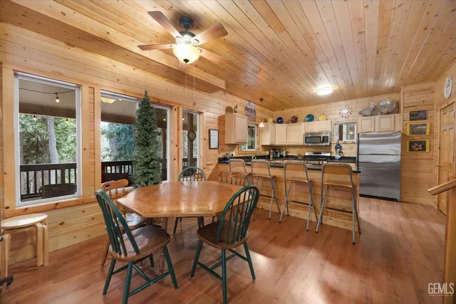 a view of a dining room with furniture wooden floor and chandelier