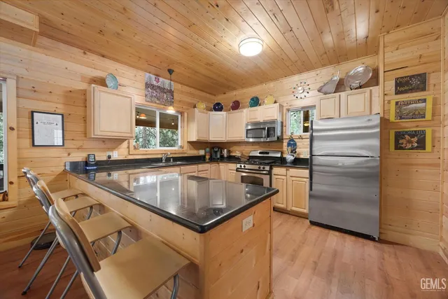 a kitchen with stainless steel appliances granite countertop a sink a stove and cabinets